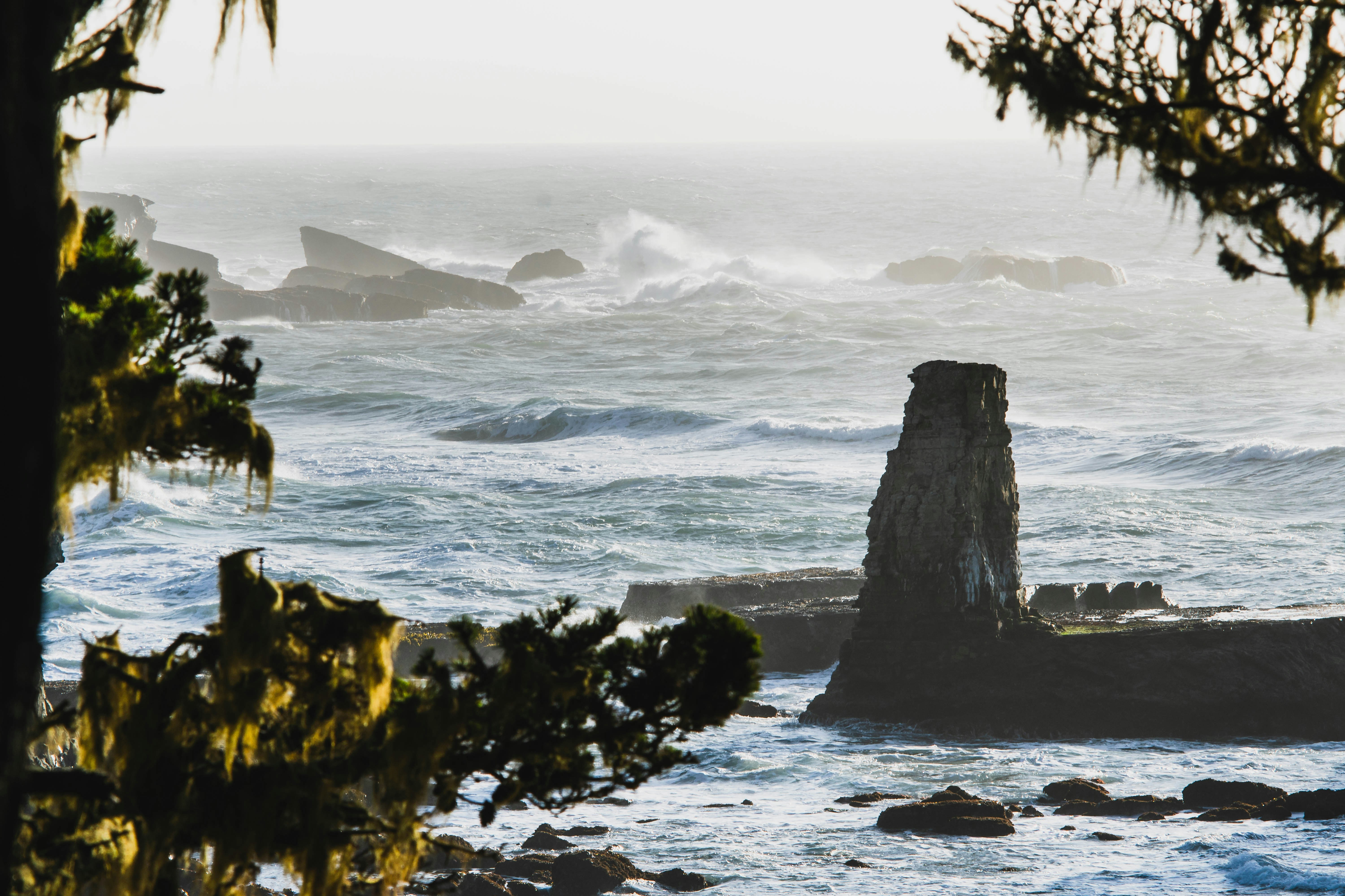 a rocky beach with waves crashing, 