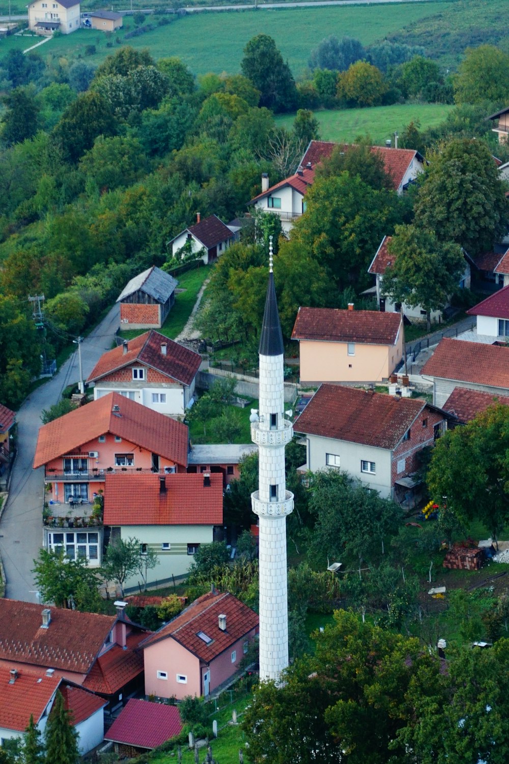 a group of houses with a tall tower in the middle