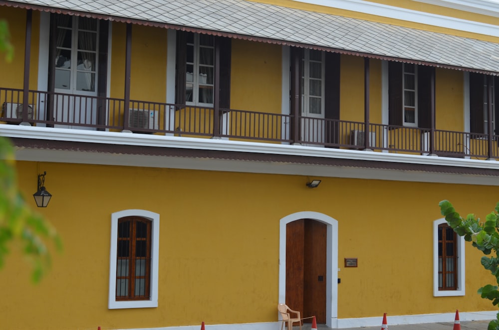 a yellow building with a balcony