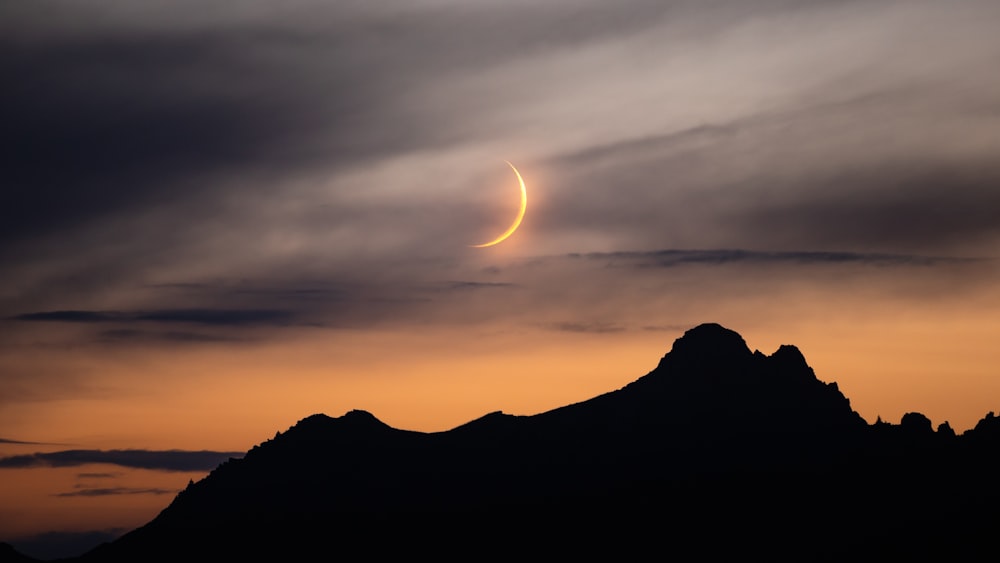 a mountain with a sunset in the background