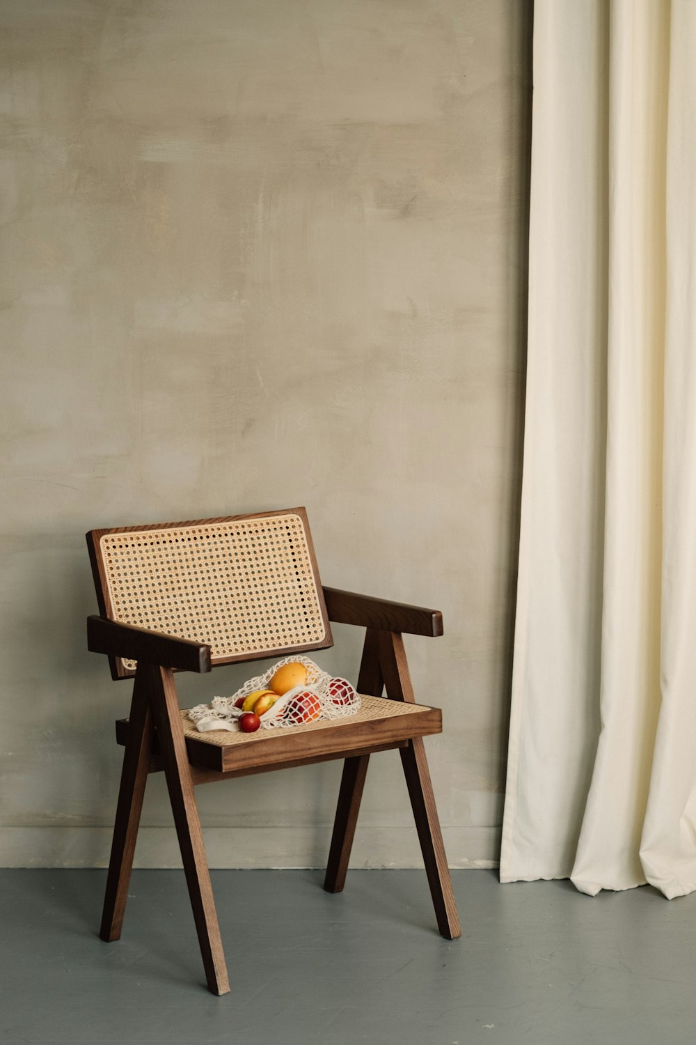 a chair with a basket of fruit on it