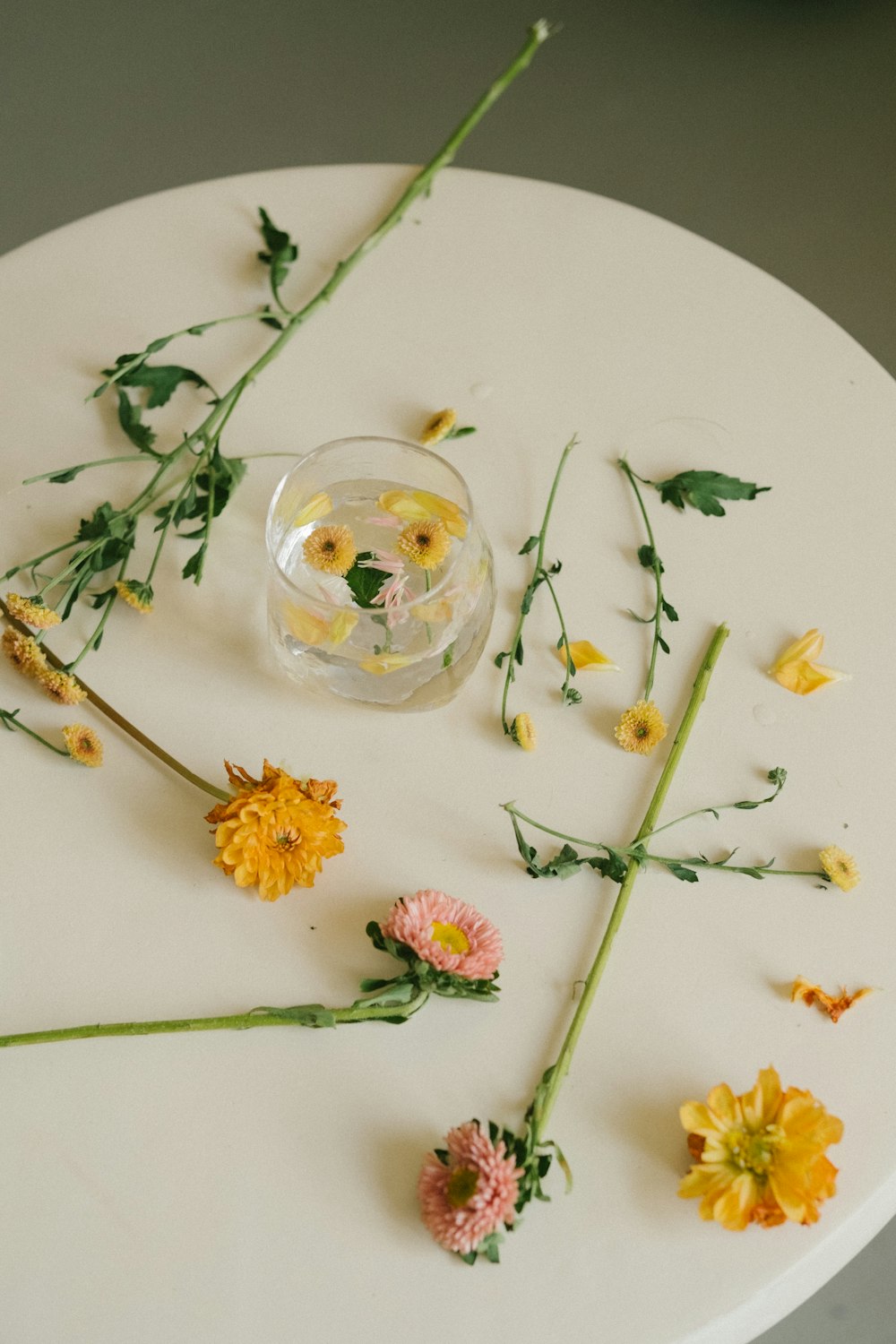 a glass with flowers in it