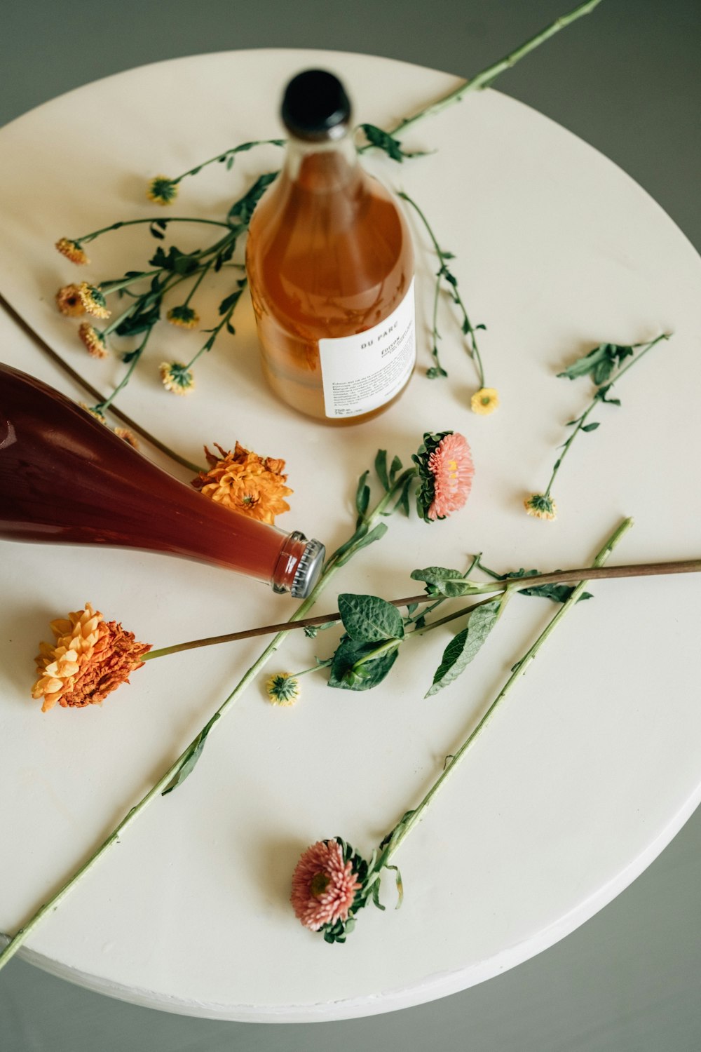 a plate with food and a bottle of liquor on it