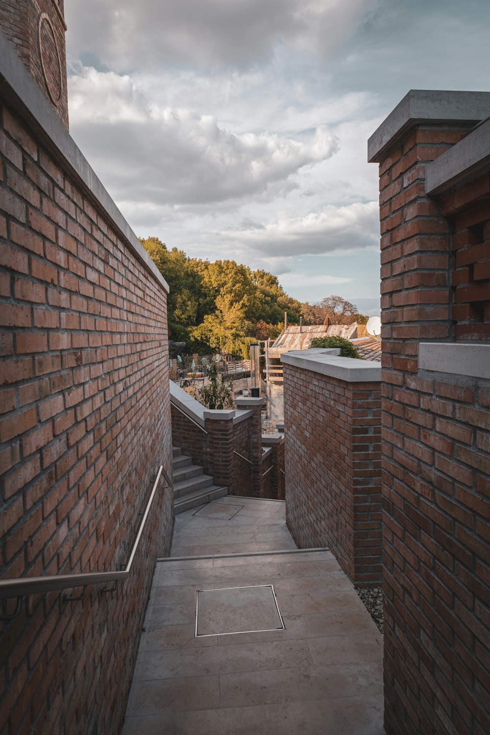 a brick walkway between brick walls