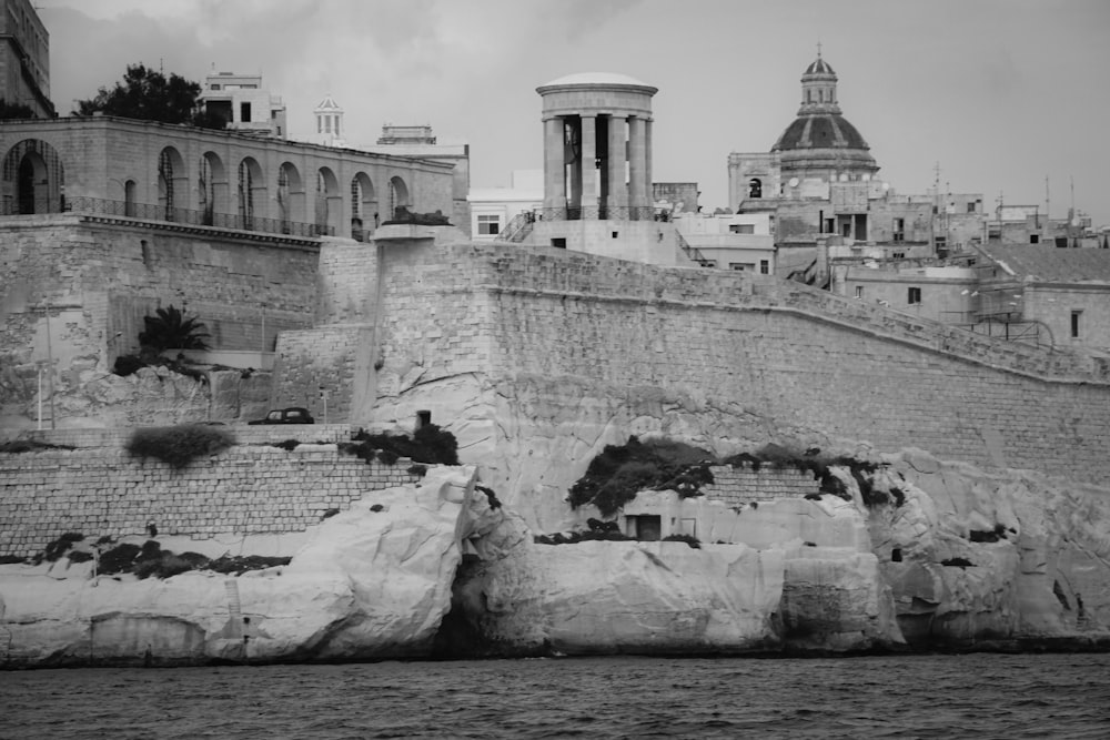 a large stone building with a large waterfall