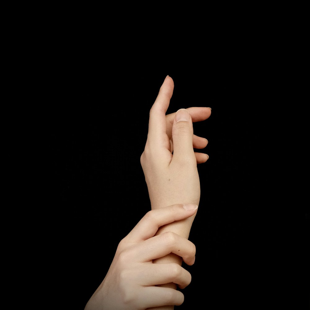 a hand with a black background