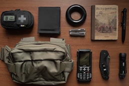 Compact self-defense tools arranged neatly on a dark tactical mat.