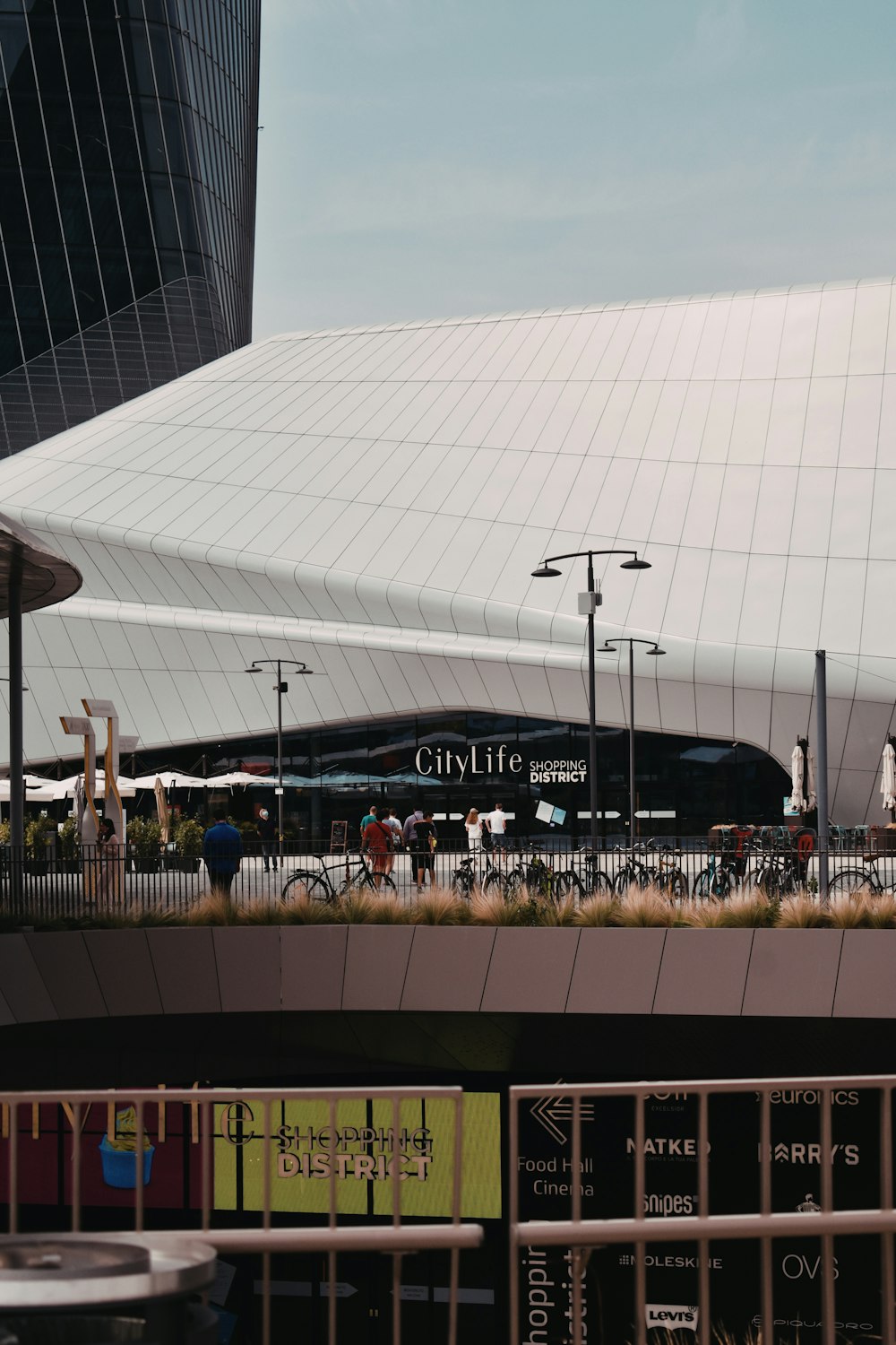 a large stadium with people standing in front of it