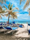 a beach with chairs and tables