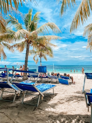 a beach with chairs and tables