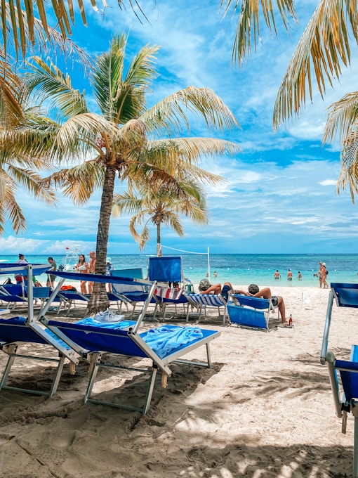 a beach with chairs and tables
