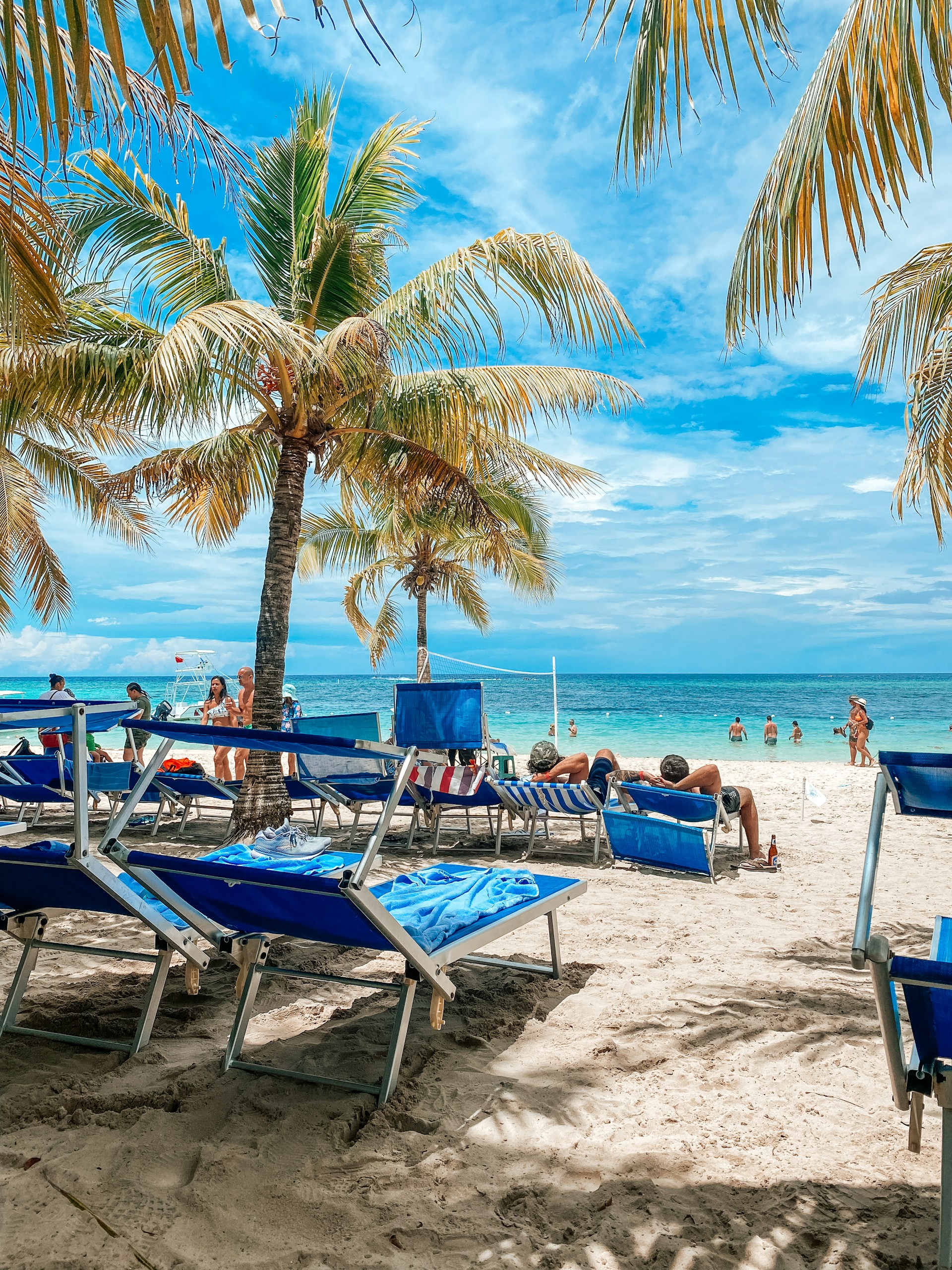 a beach with chairs and tables