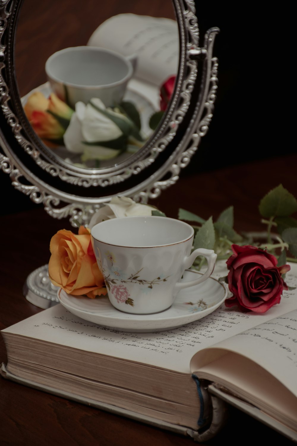 a couple of tea cups on a saucer next to a plate of food