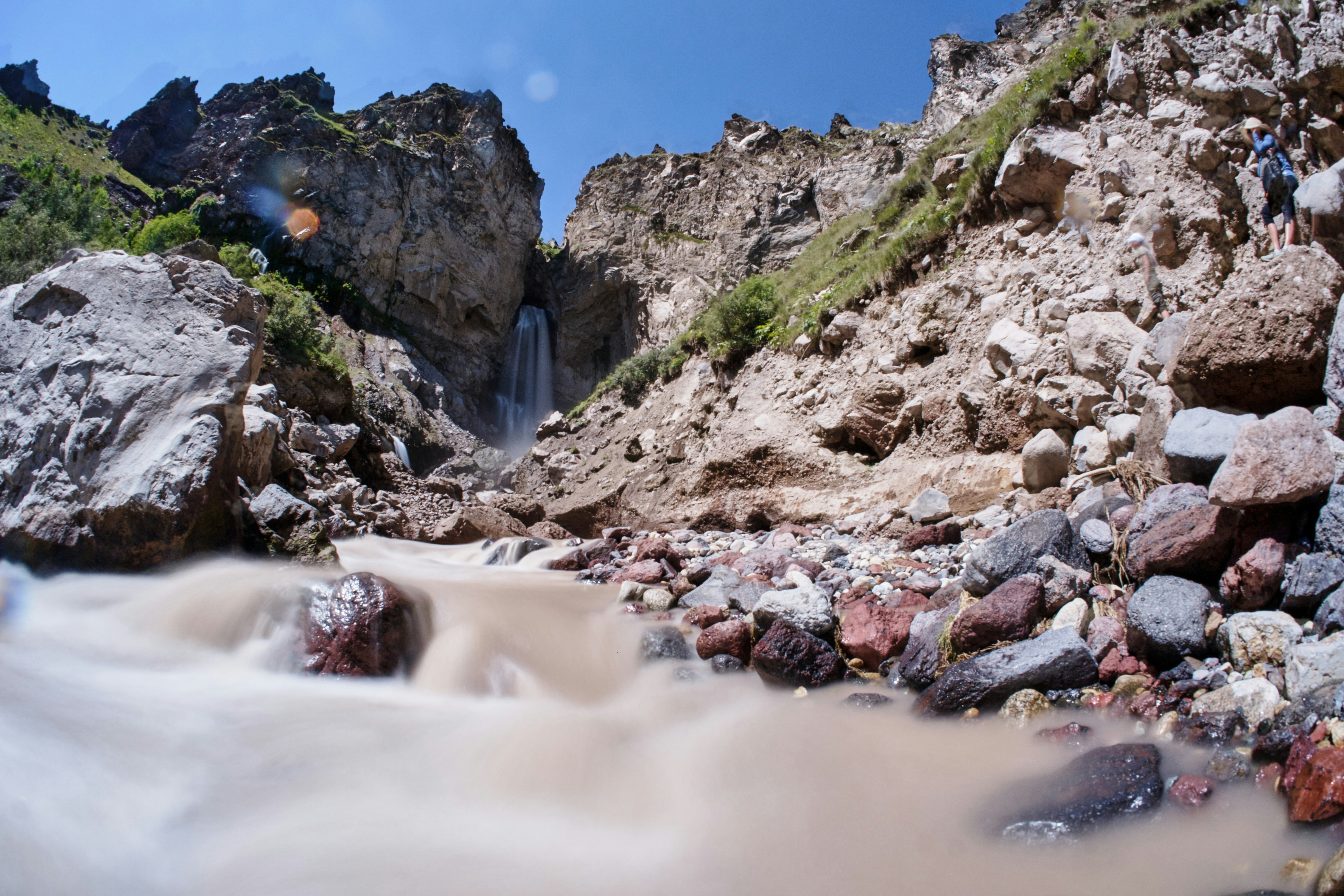 a rocky beach with a stream