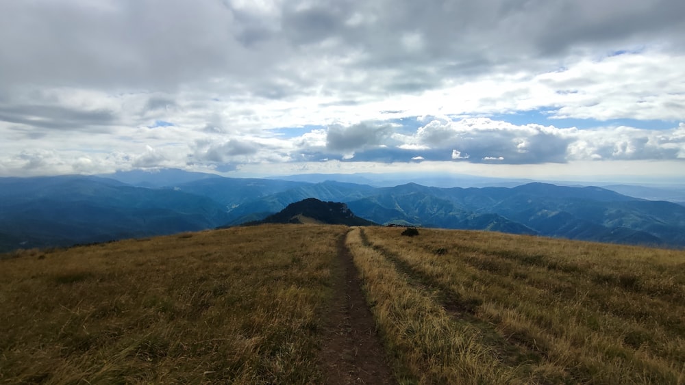 a dirt road leading to a mountain