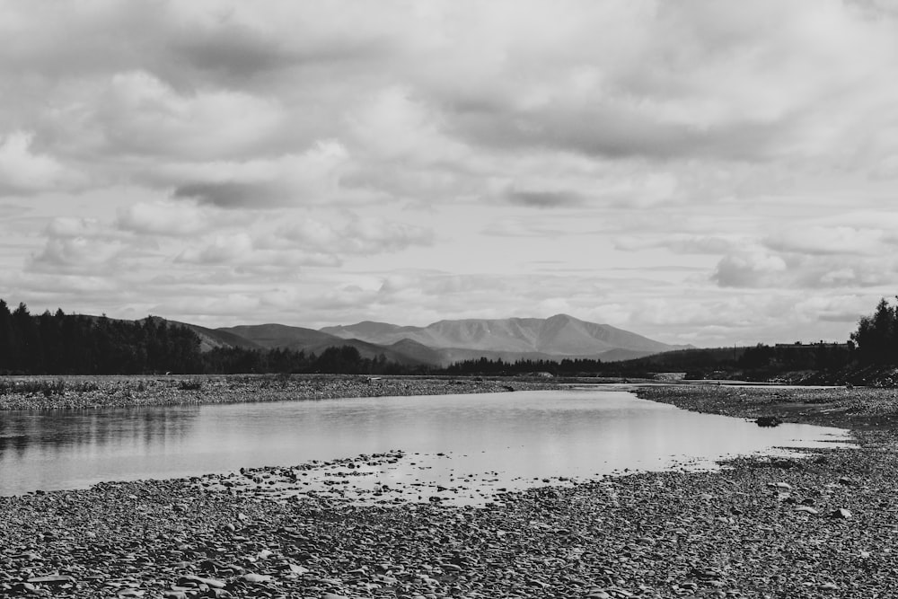 a lake with mountains in the background