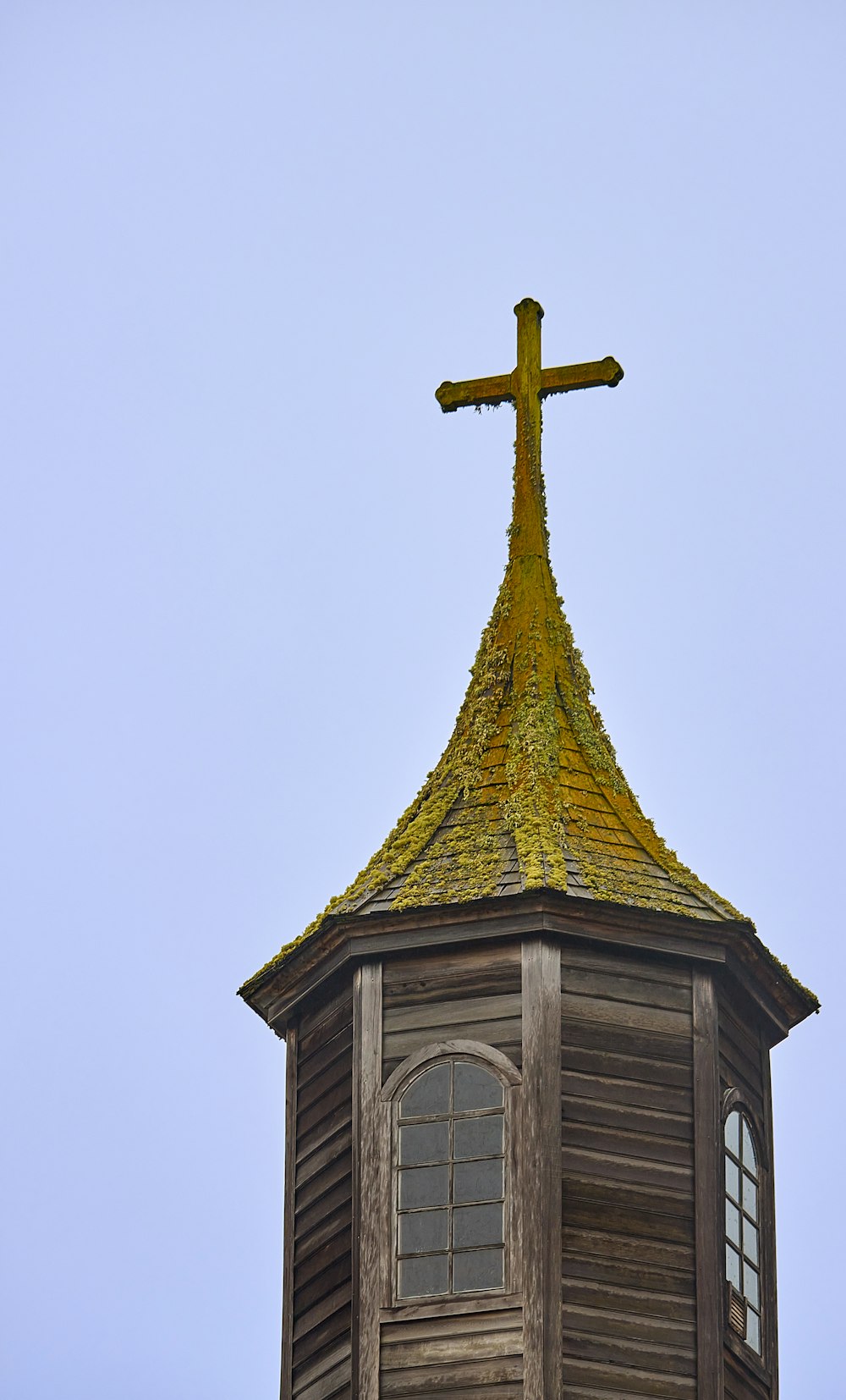a tall building with a cross on top