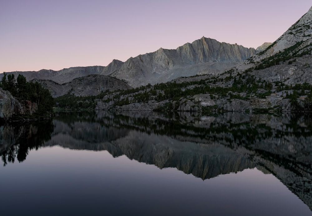 a lake with snow covered mountains