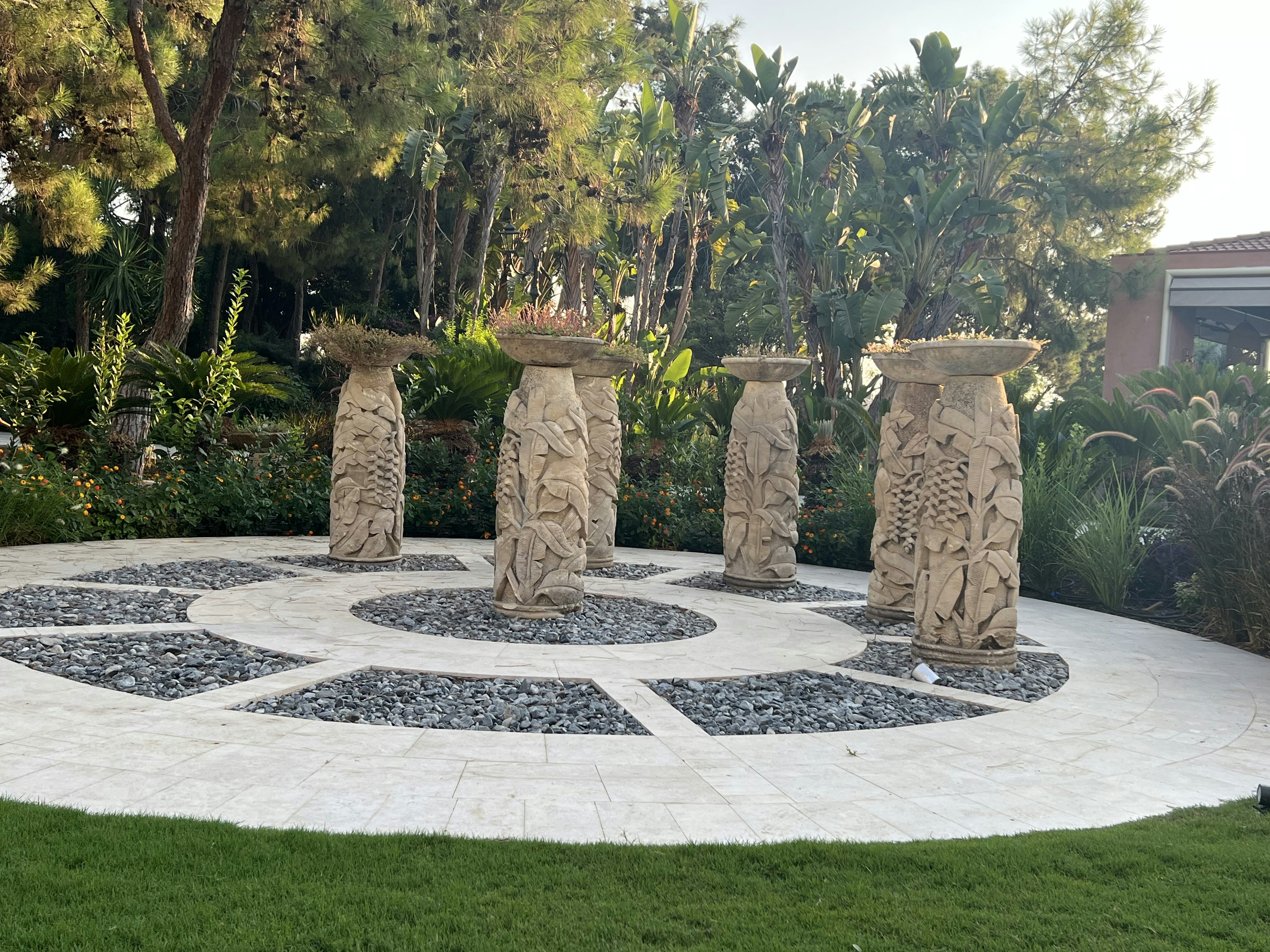 a group of stone statues in a garden