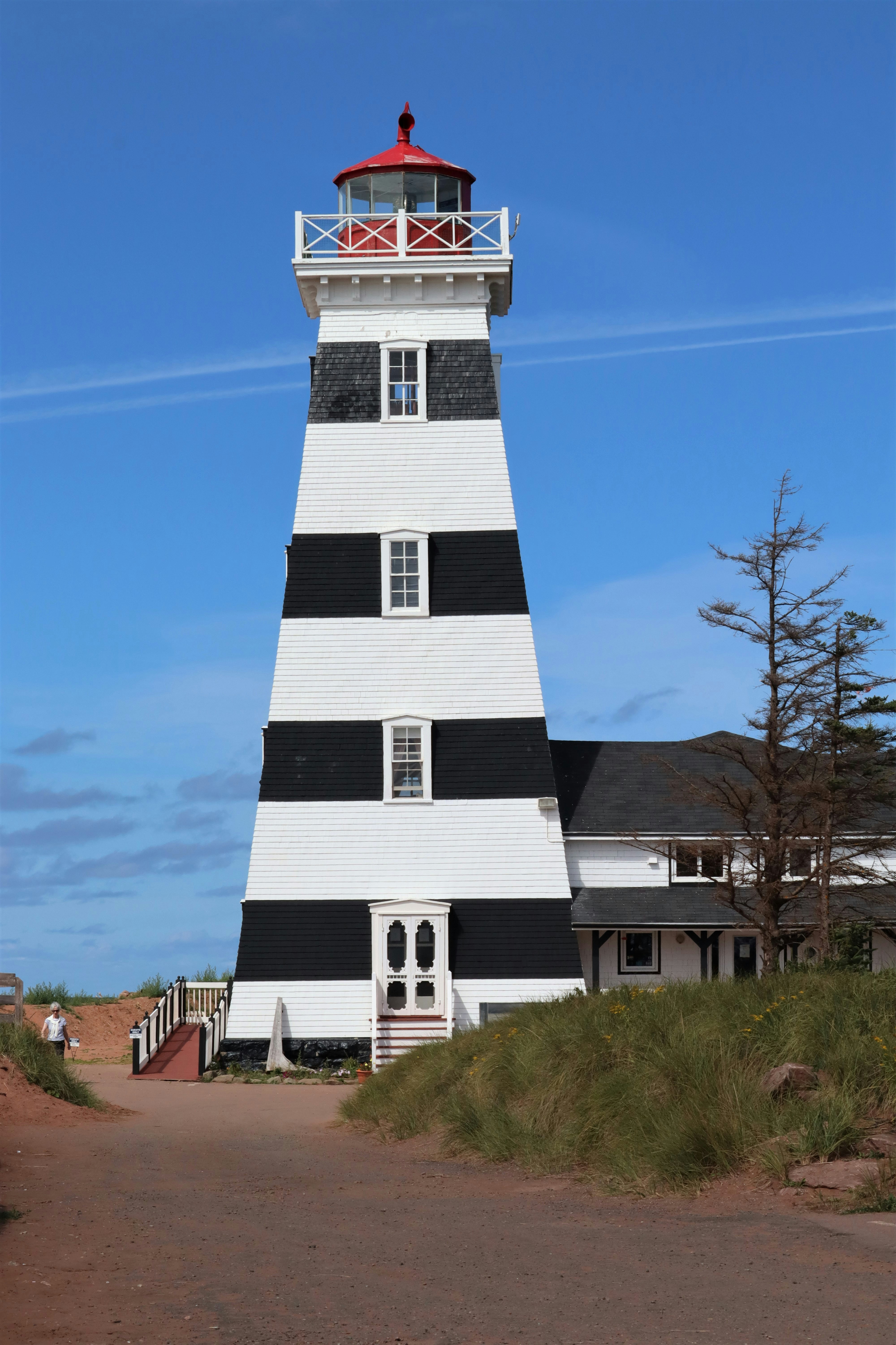 a lighthouse with a red and white top