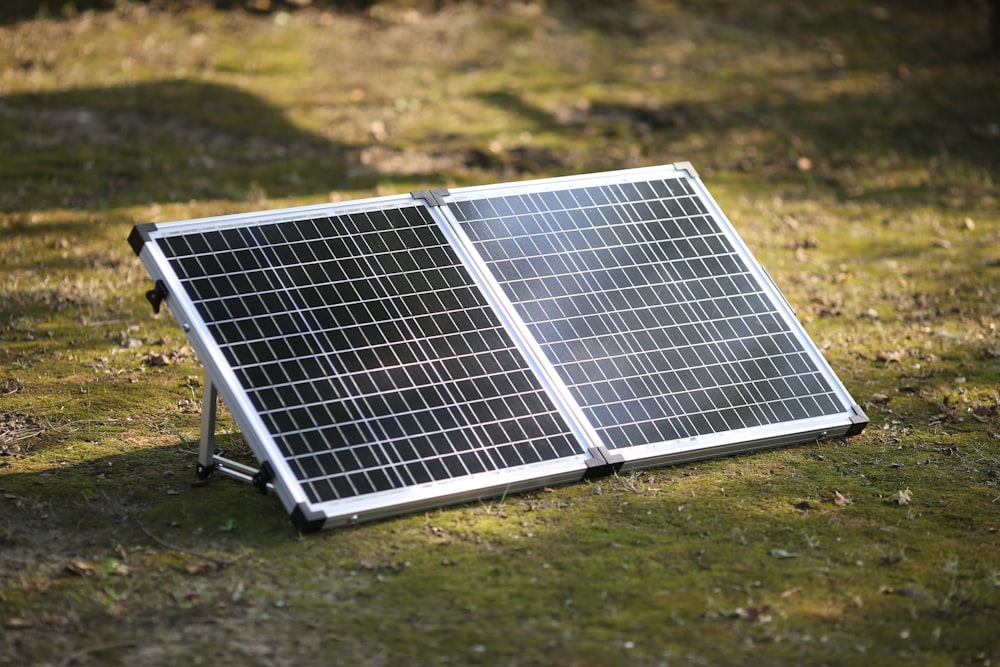 a solar panel on a grass field