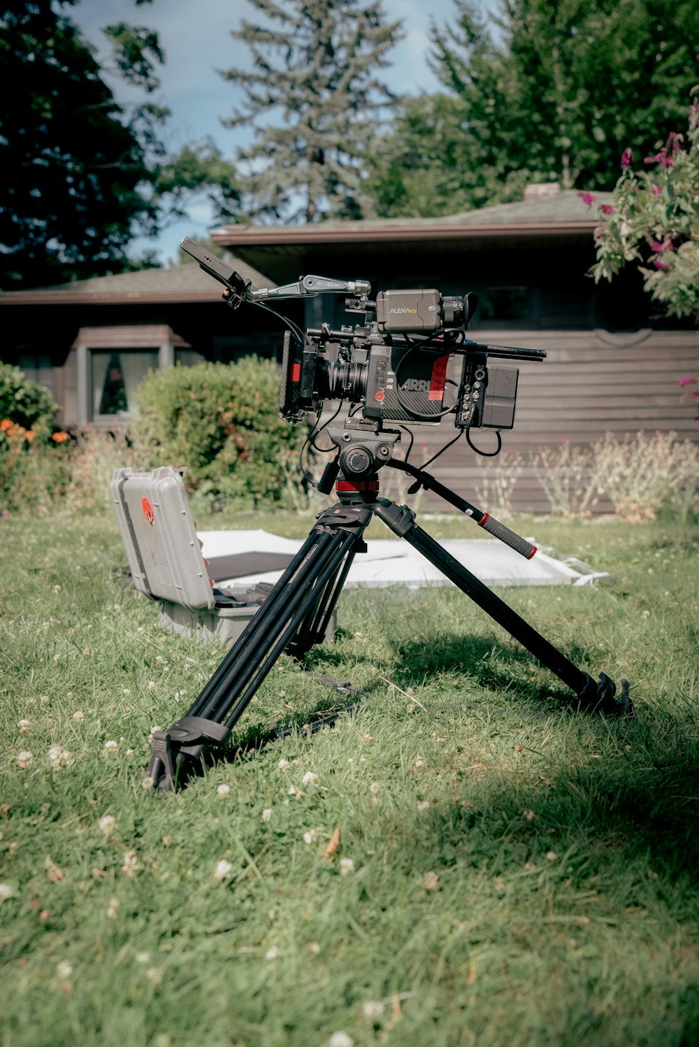 a camera on a tripod in a yard