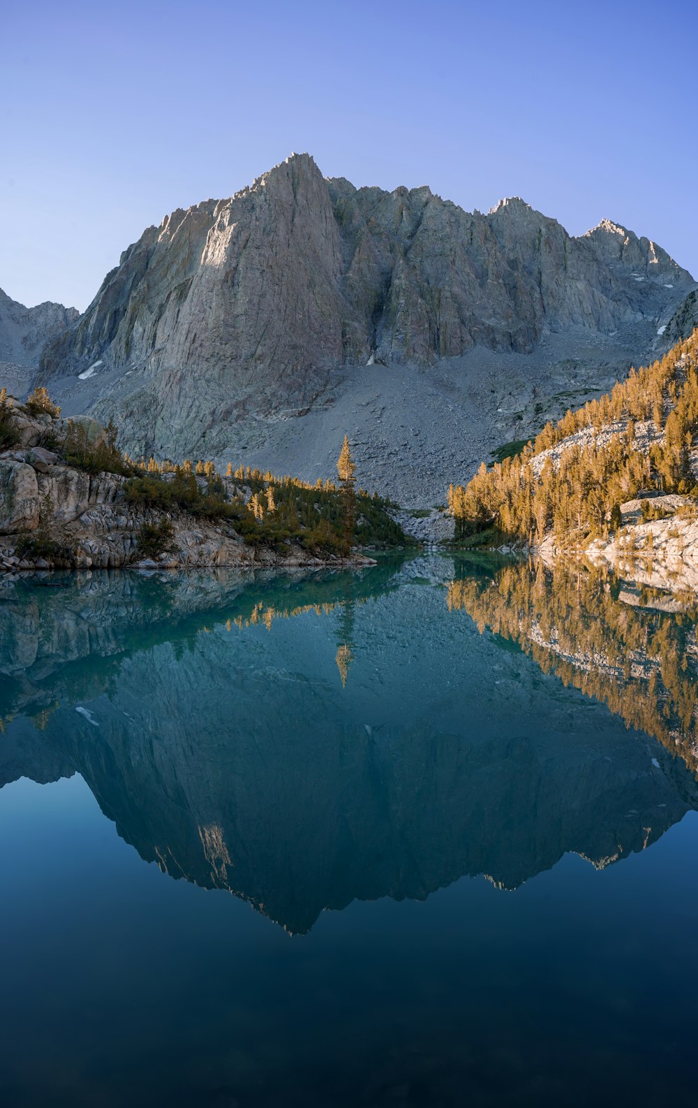 a body of water with a mountain in the background