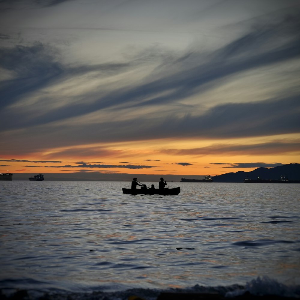 a couple people in a boat in the water