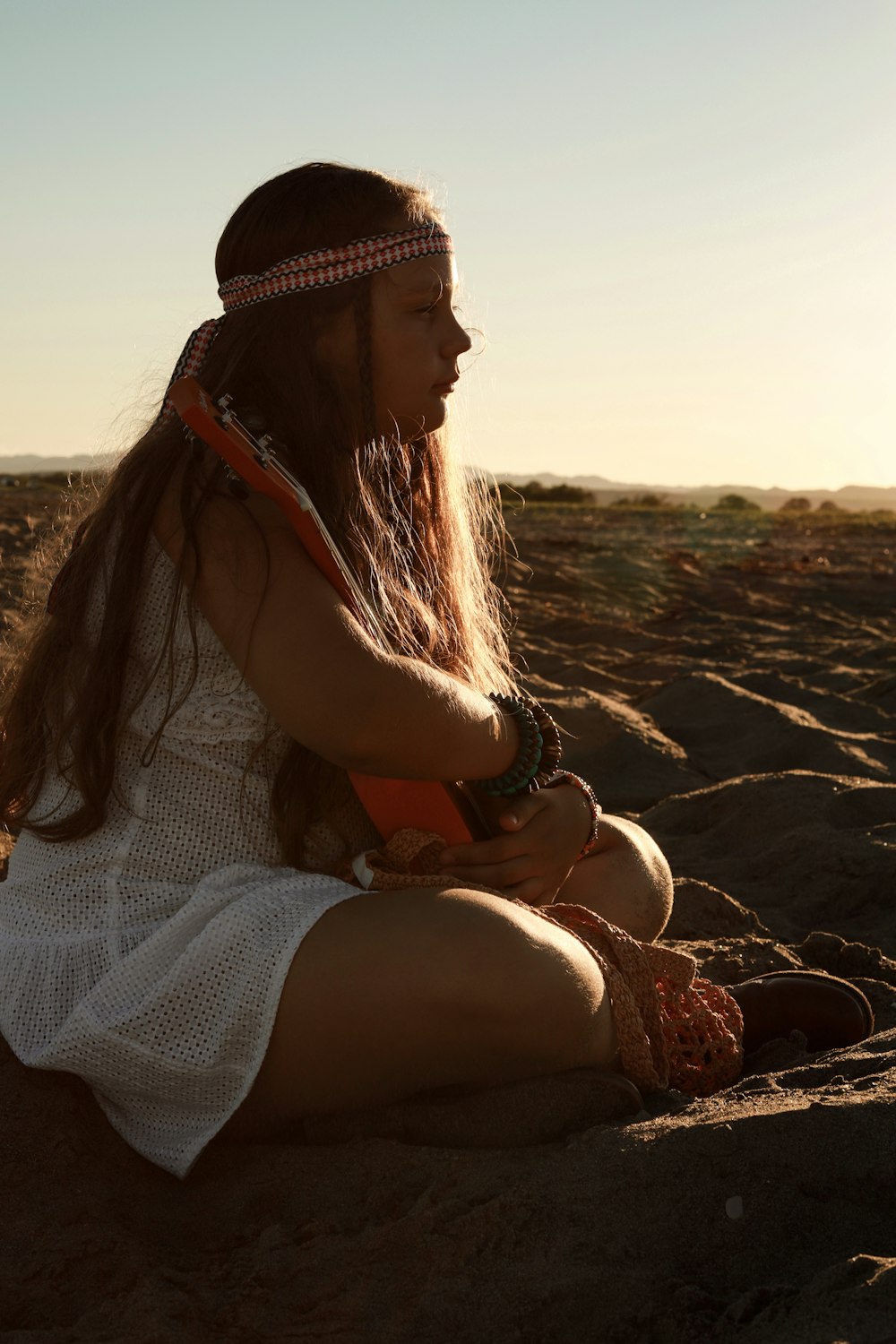 a woman sitting on a beach