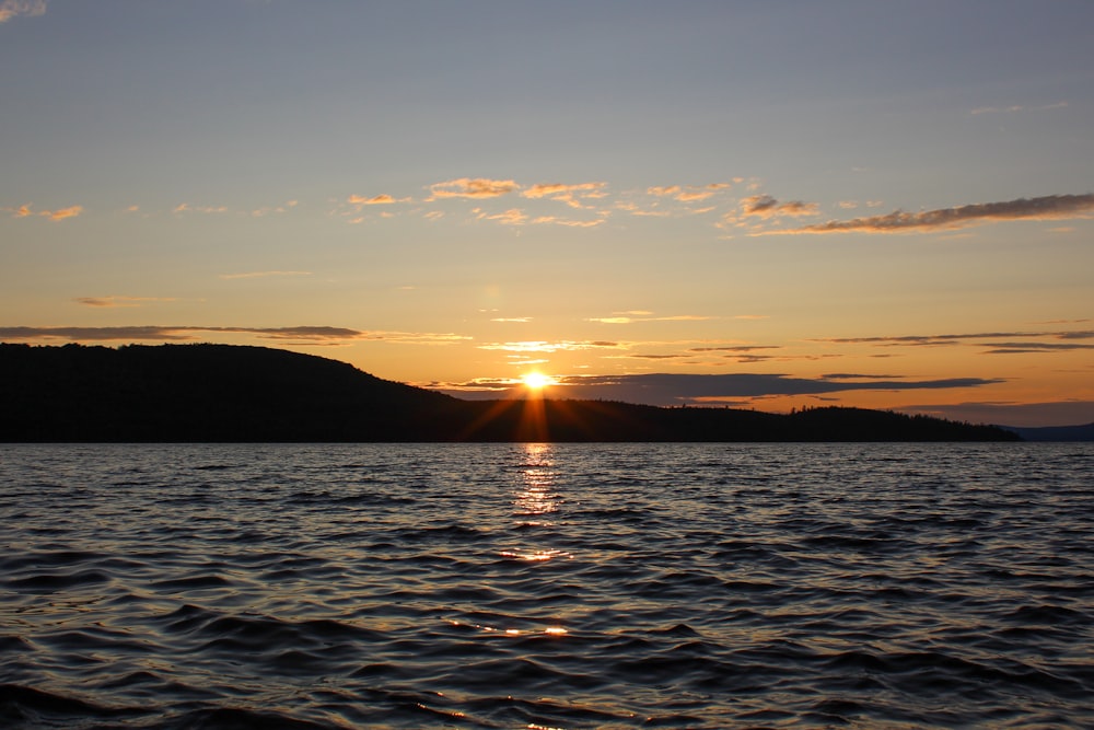 a sunset over a body of water