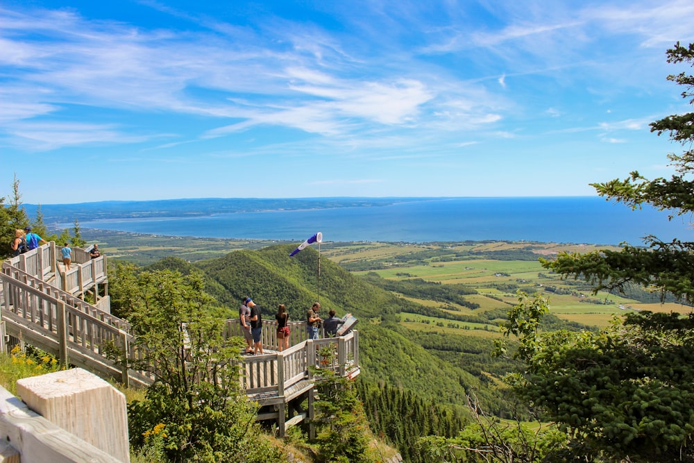 a group of people on a balcony overlooking a green landscape