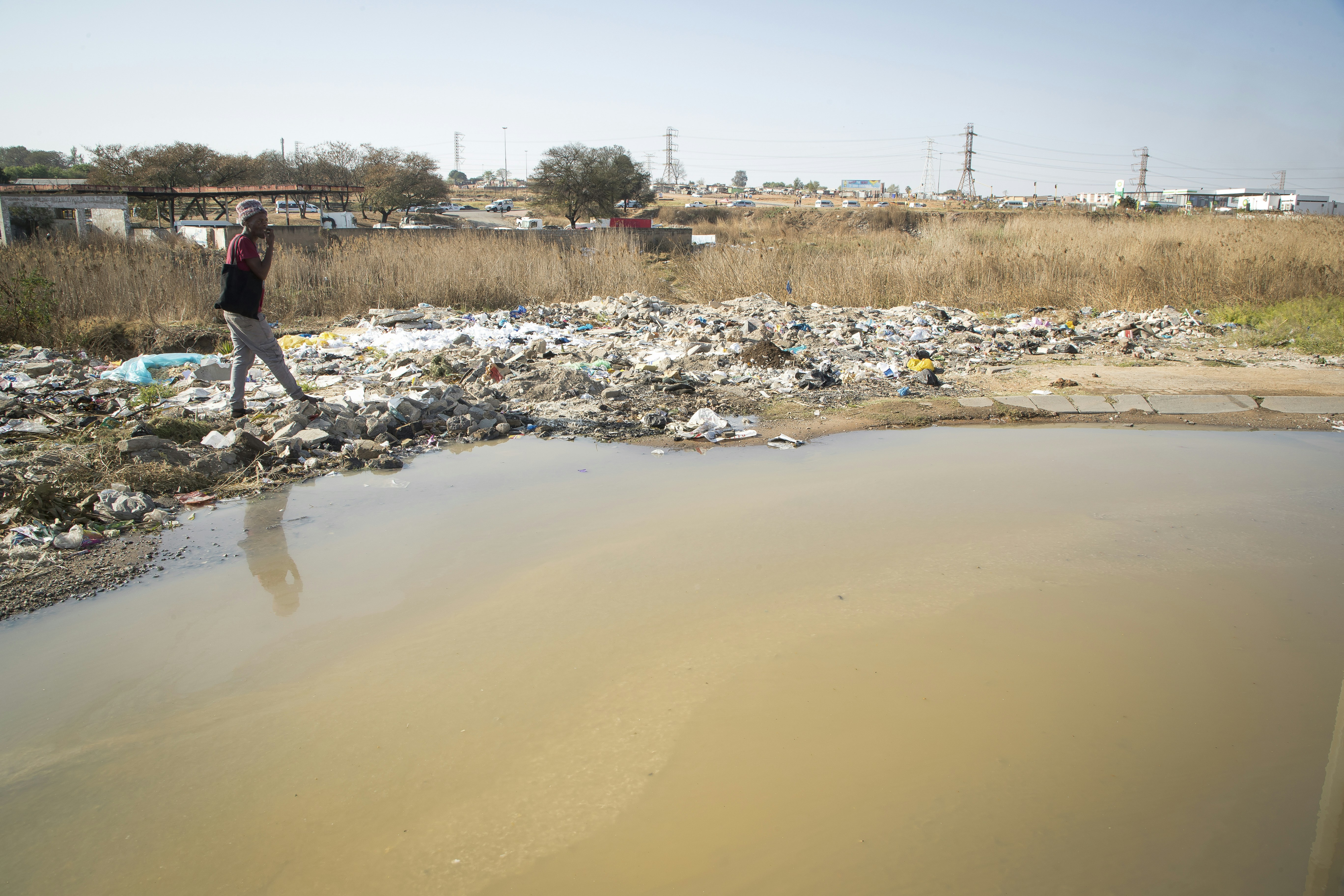 a man walking in a muddy area