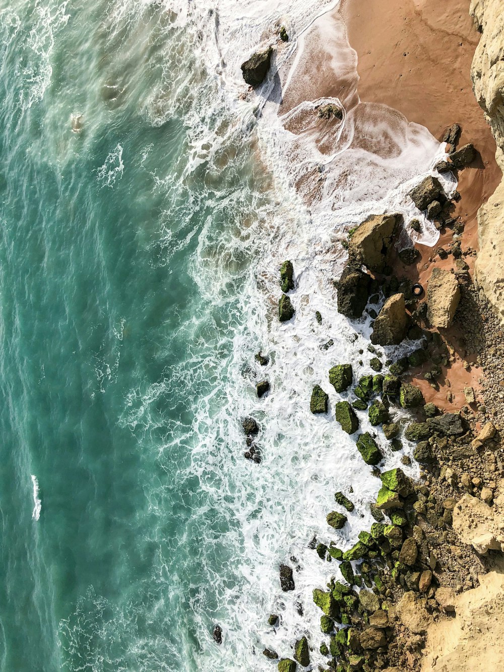 a rocky beach with a body of water