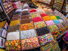 A friendly shop counter stacked with colorful sweets and chocolates in Leeds.