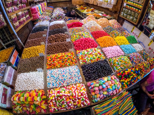 A colorful assortment of various candies and chocolates displayed in a market setting.