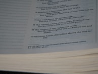 An open page from a book, likely a religious or philosophical text, with several verses or proverbs printed in a neat and orderly fashion. The text is clear and appears to offer wisdom or moral guidance.