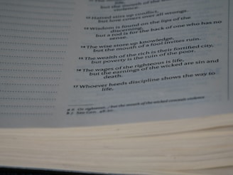 An open page from a book, likely a religious or philosophical text, with several verses or proverbs printed in a neat and orderly fashion. The text is clear and appears to offer wisdom or moral guidance.