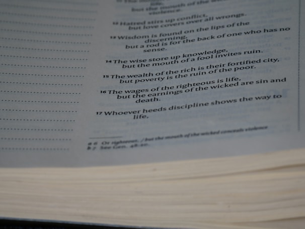 An open page from a book, likely a religious or philosophical text, with several verses or proverbs printed in a neat and orderly fashion. The text is clear and appears to offer wisdom or moral guidance.