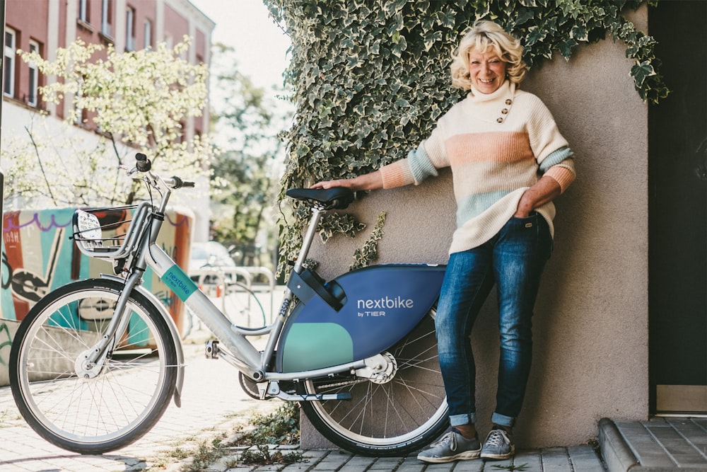 a woman leaning against a bicycle