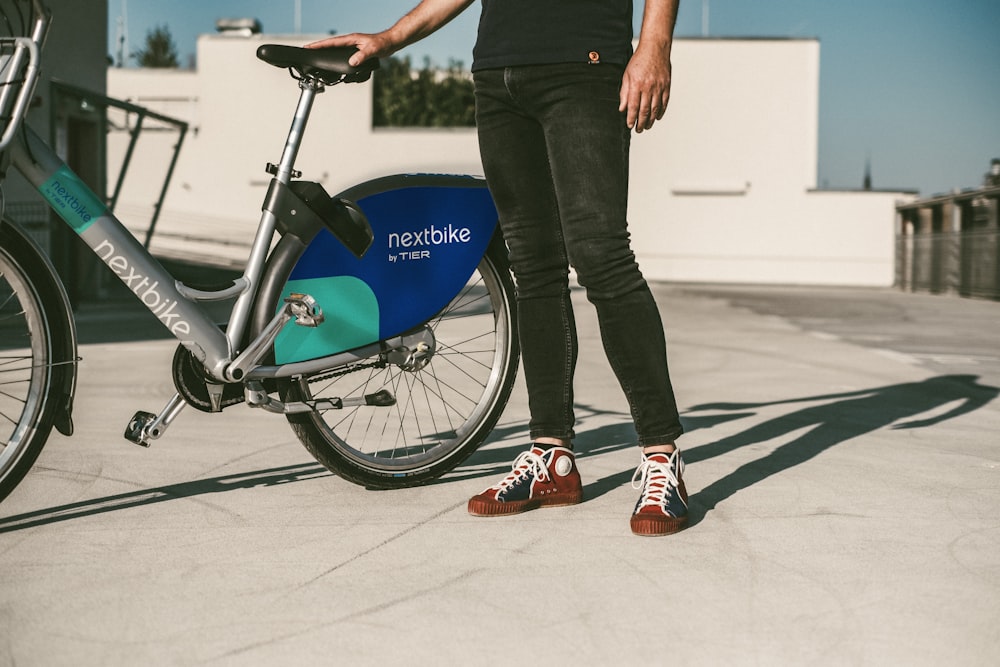 a person standing next to a bike