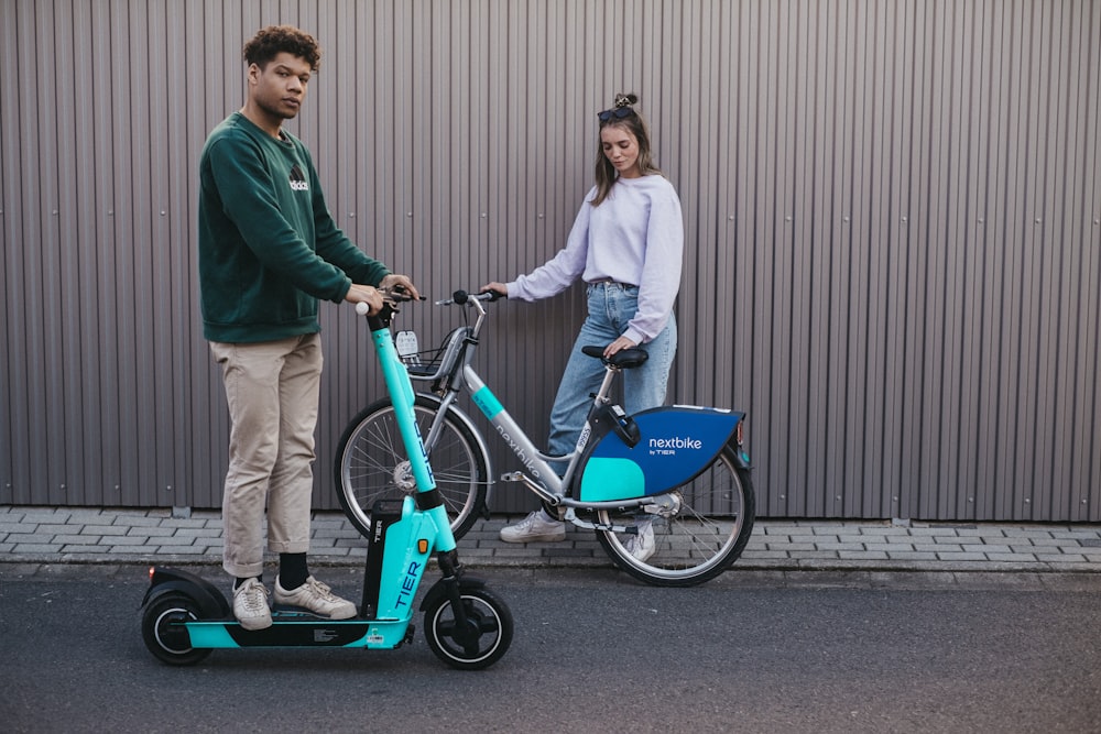a man and a woman on a small blue bicycle