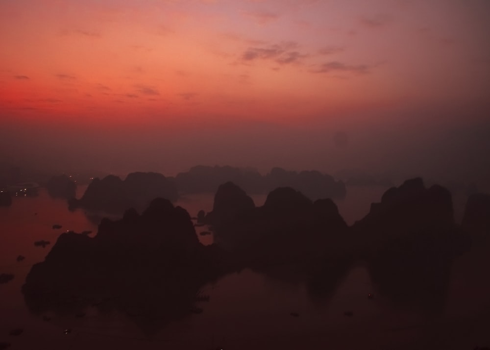 a sunset over a rocky landscape