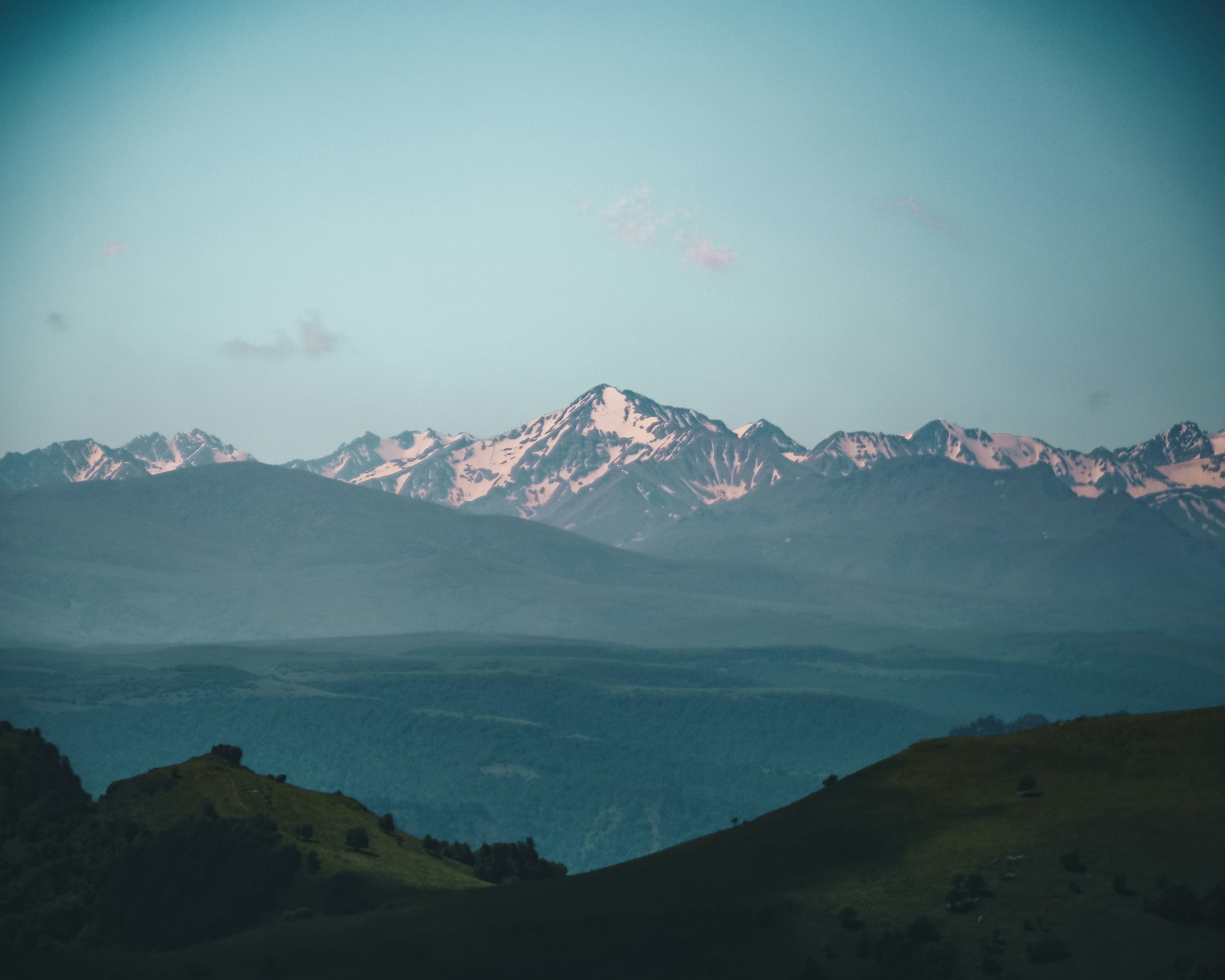 A body of water with mountains in the back