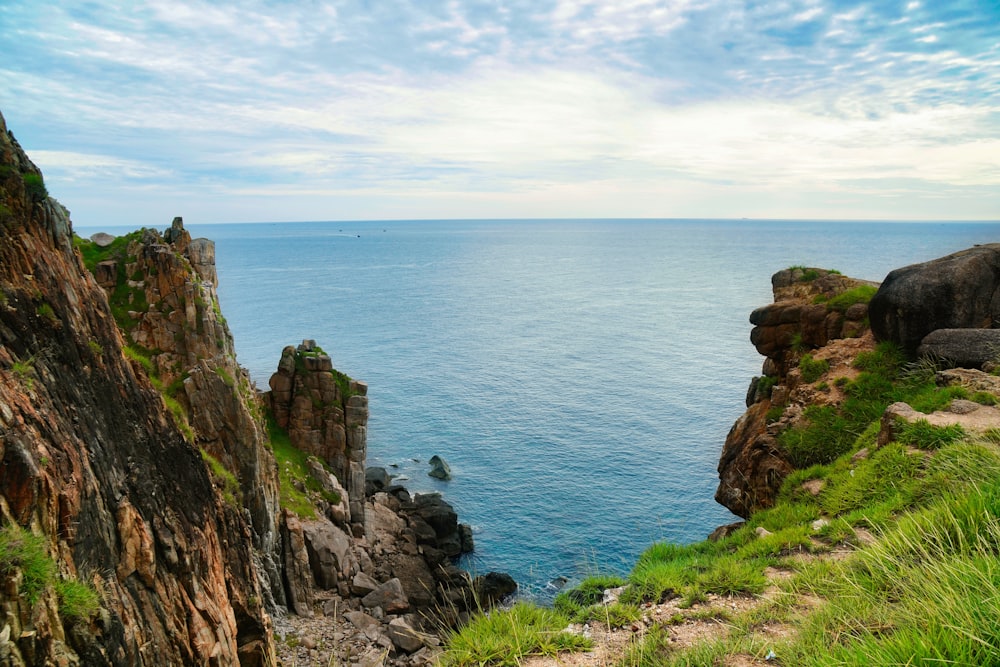 a rocky cliff overlooking a body of water