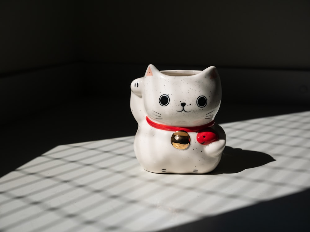 a small white cat figurine