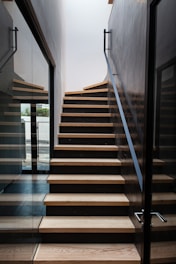 a wooden staircase with glass doors