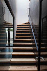 a wooden staircase with glass doors