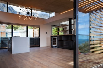 a room with a wood floor and large windows
