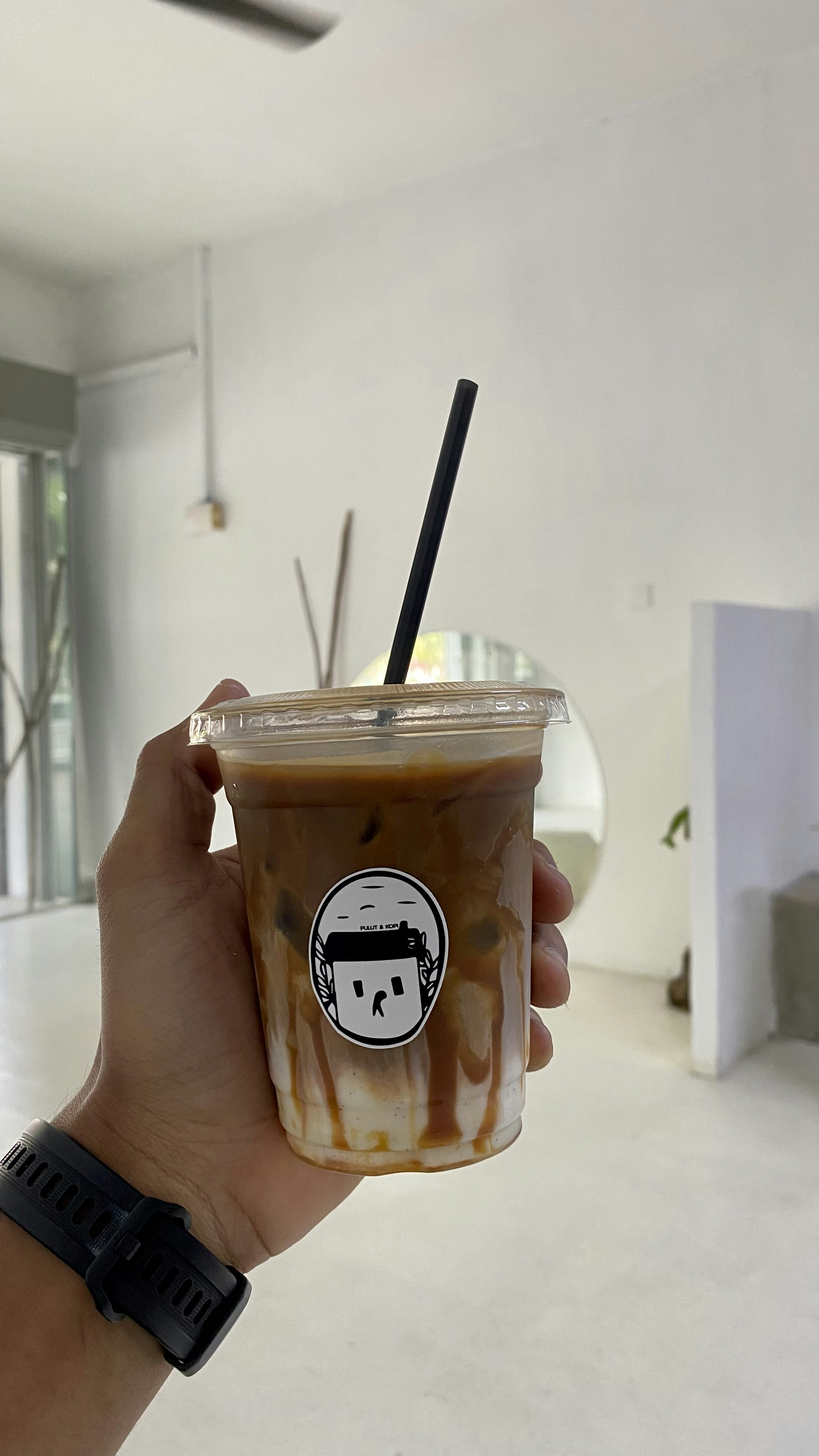 Cold brew coffee in a tall glass with ice and a caramel drizzle