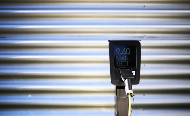 Sleek industrial chargers plugged into various electronic devices against a black backdrop